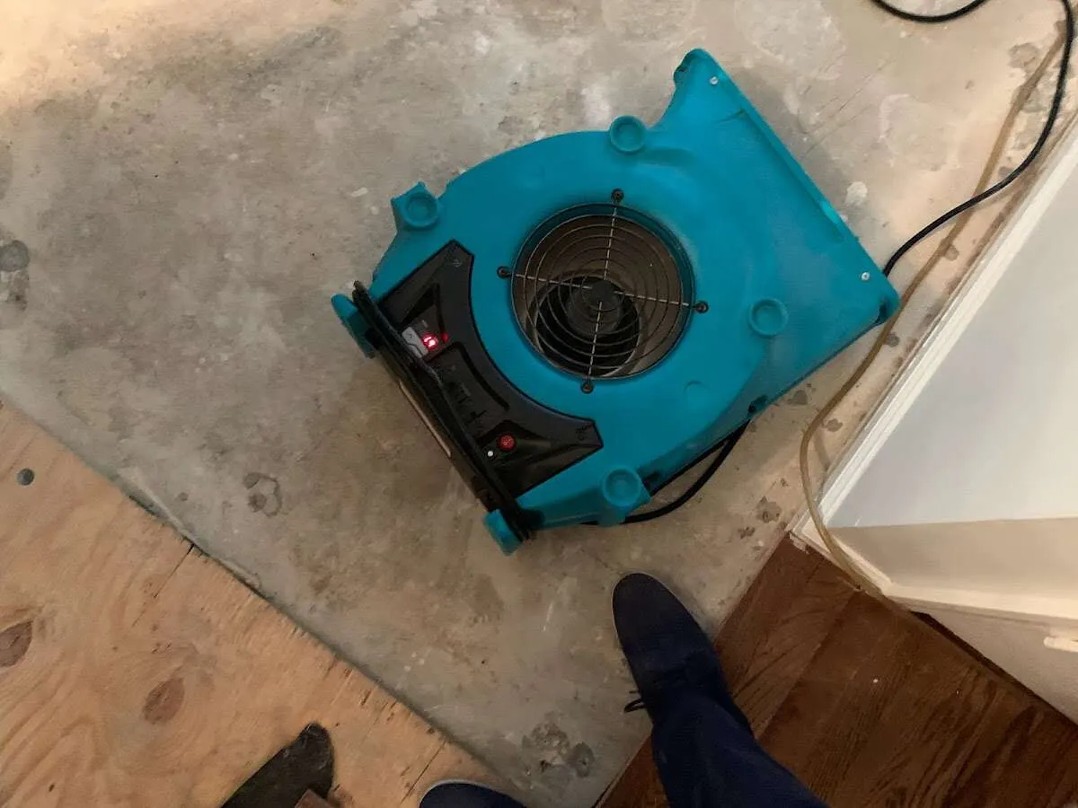 Air mover drying subfloor during Leak Detection & Repair in Adams